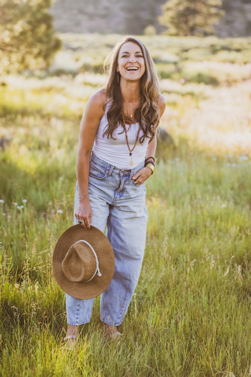 Kaila laughing in a sunlit meadow
